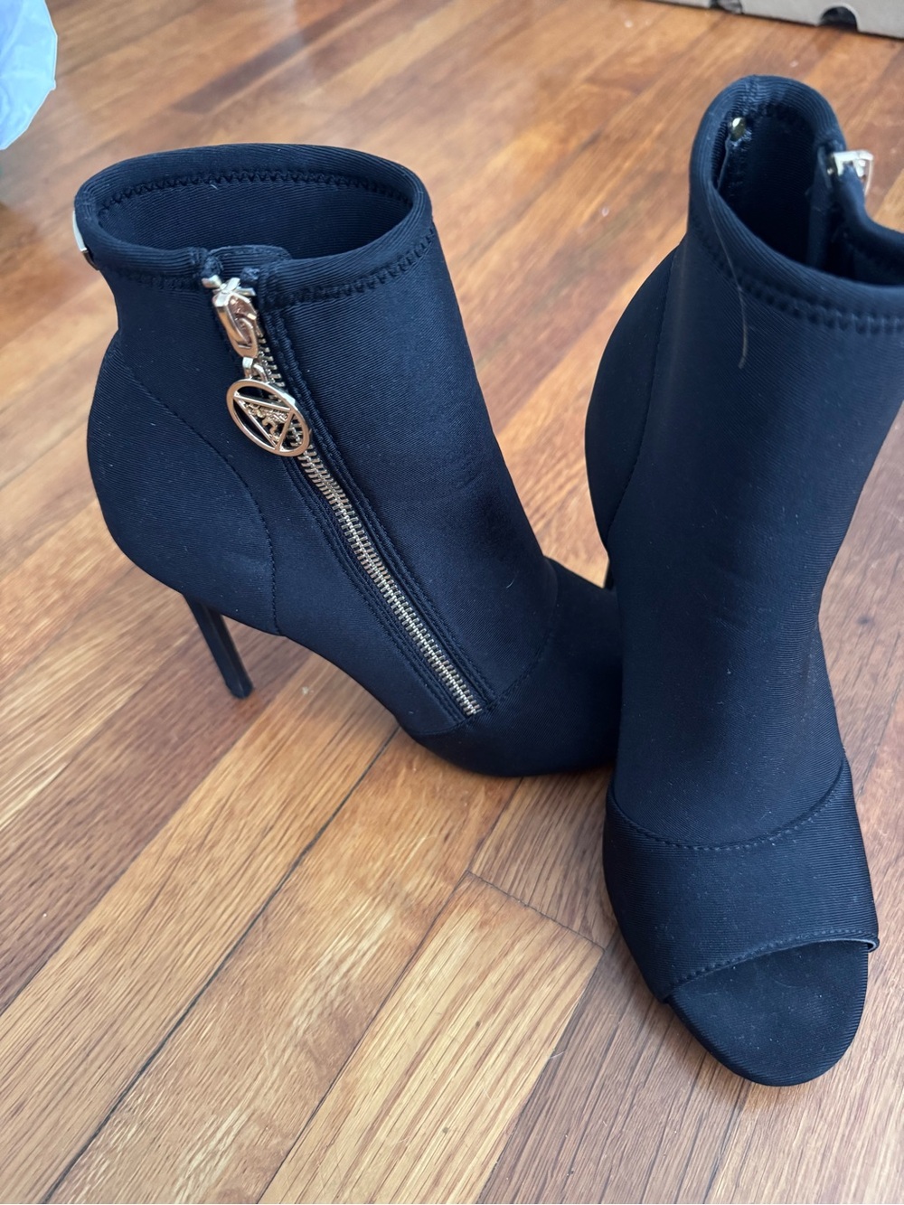 Guess Black Peep-Toe Stiletto Ankle Boots with Gold Logo Zip